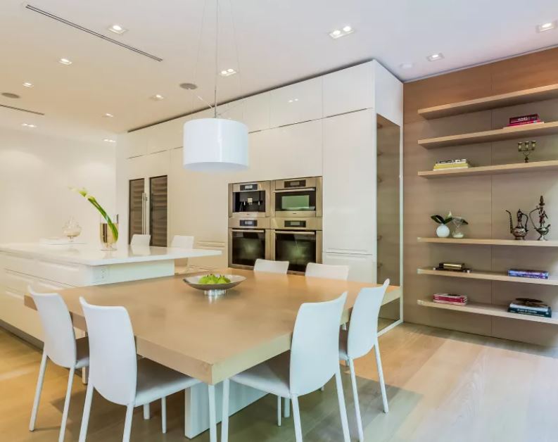 Shakira's Modern kitchen with large entertaining space, double oven and expansive wine refrigerator. 